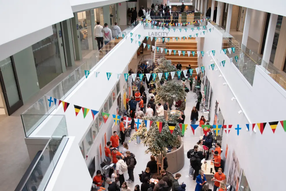 En ljus, öppen och avlång lokal med ett folkmyller.