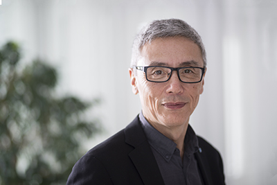 Portrait of a man with gray hair and black glasses. Photo.