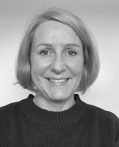 Black and white photo of a smiling woman.