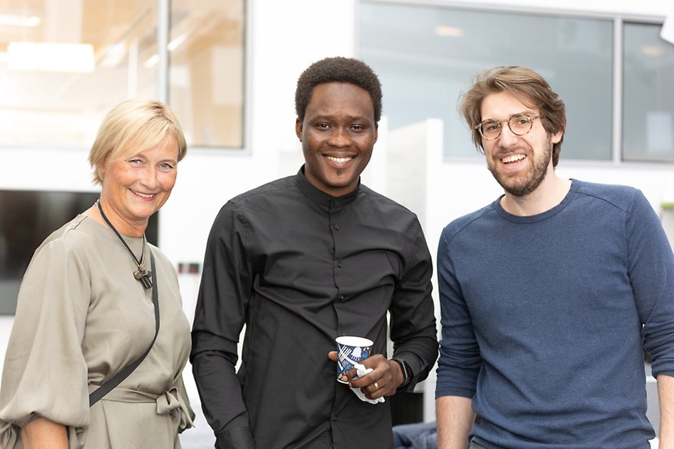 Three people looking into the camera smiling. Photo.