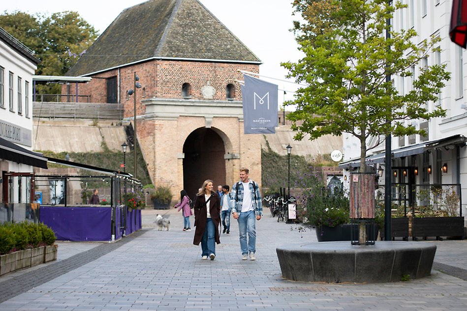 Town center, young persons walking in the street. Photo.