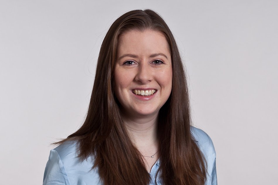 Portrait of a person with long, dark hair. Photo.