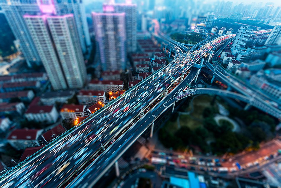 Aerial photo of a city landscape, a busy motorway in the centre