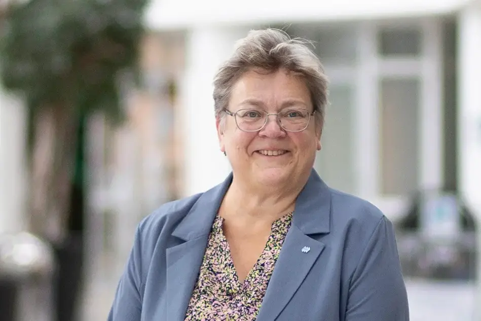 Portrait of a person in an indoor environment.