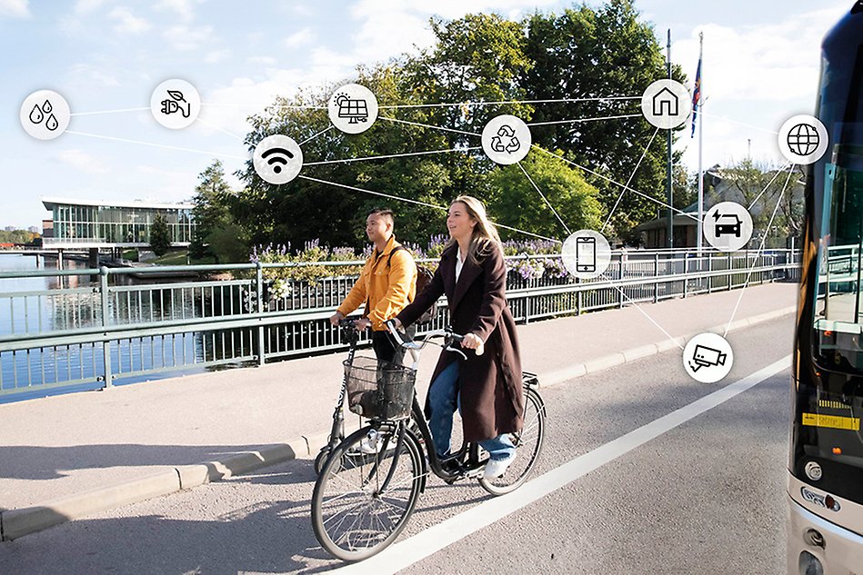 Two persons with bicycles on a bridge in town. Techsymbols surronding them. Photo and illustration.