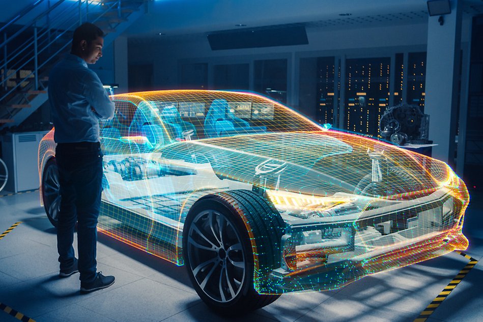 A person stands infront of a digital car in a room – it looks like a hologram.