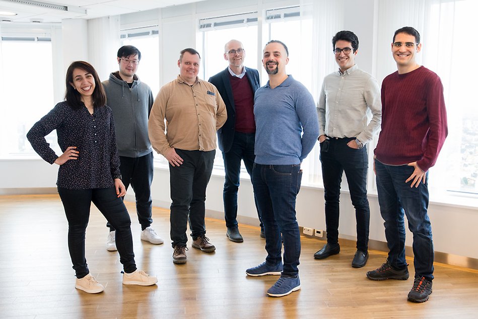 A group of people standing and smiling at the camera. Photo.