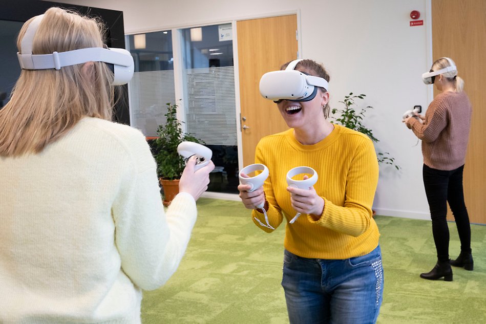 Three people doing activities with VR goggles on. Photo. 