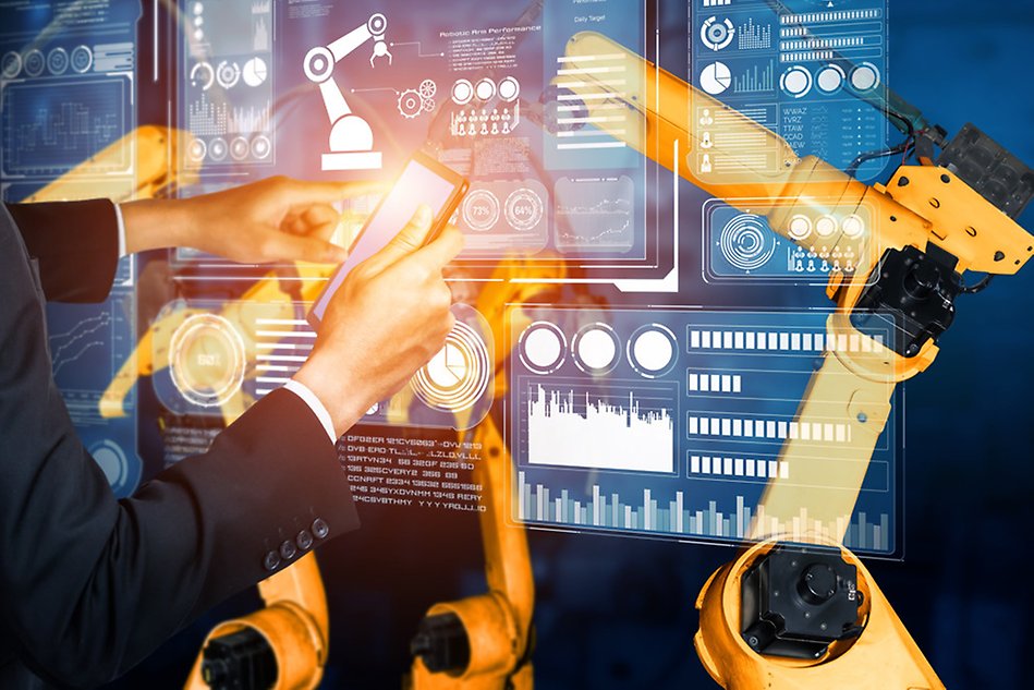 A man works with different machines infront of a screen.