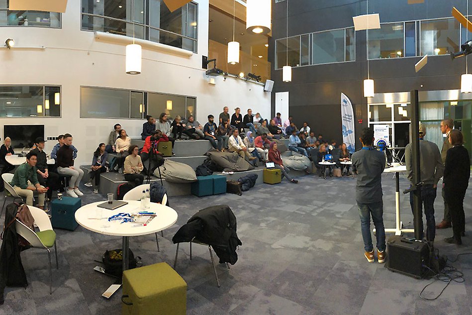 Open room with people sitting on stairs