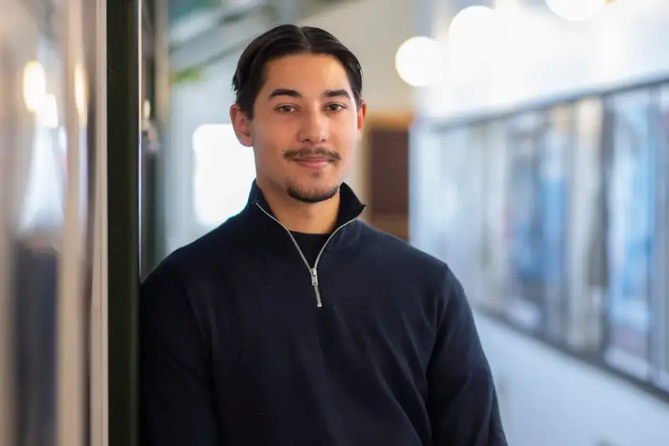 Porträtt på en ung man med en videokamera i handen. Foto.