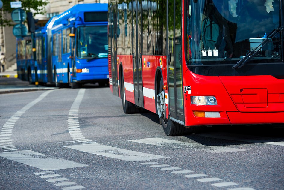 Two buses in traffic. Photo.