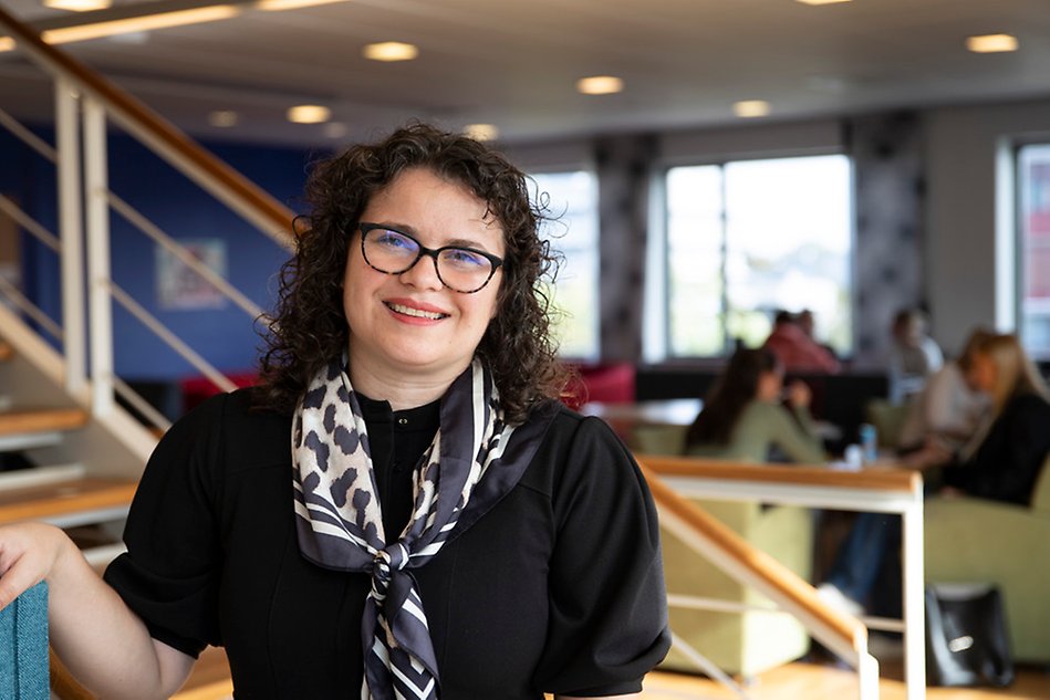 Woman with glasses smiling. Photo.