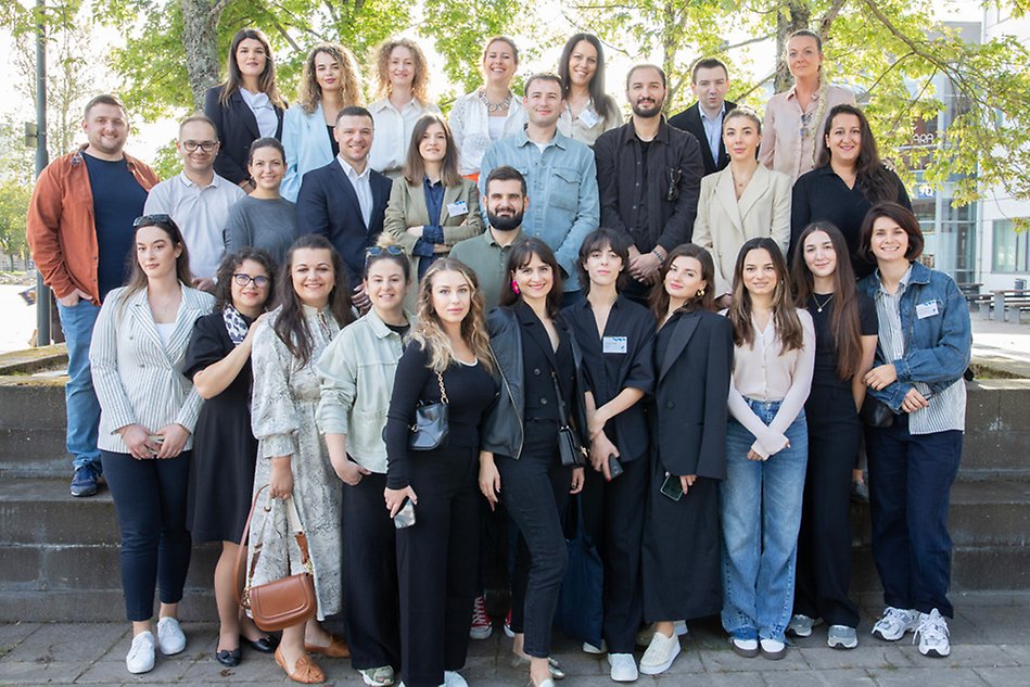 Group of young professionals visiting campus. Photo.