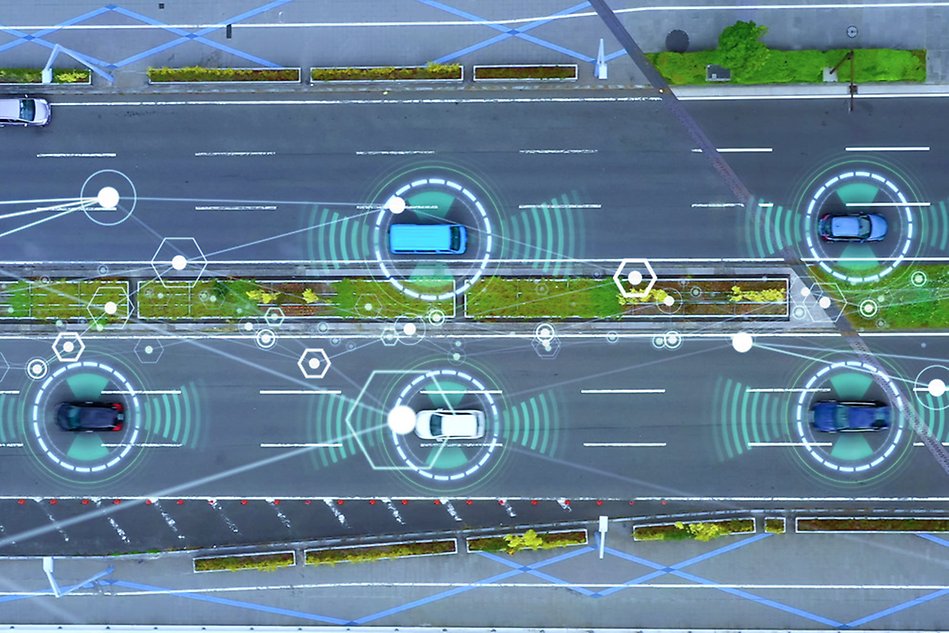 Cars on a road with graphic blue signals to illustrate that they communicate.