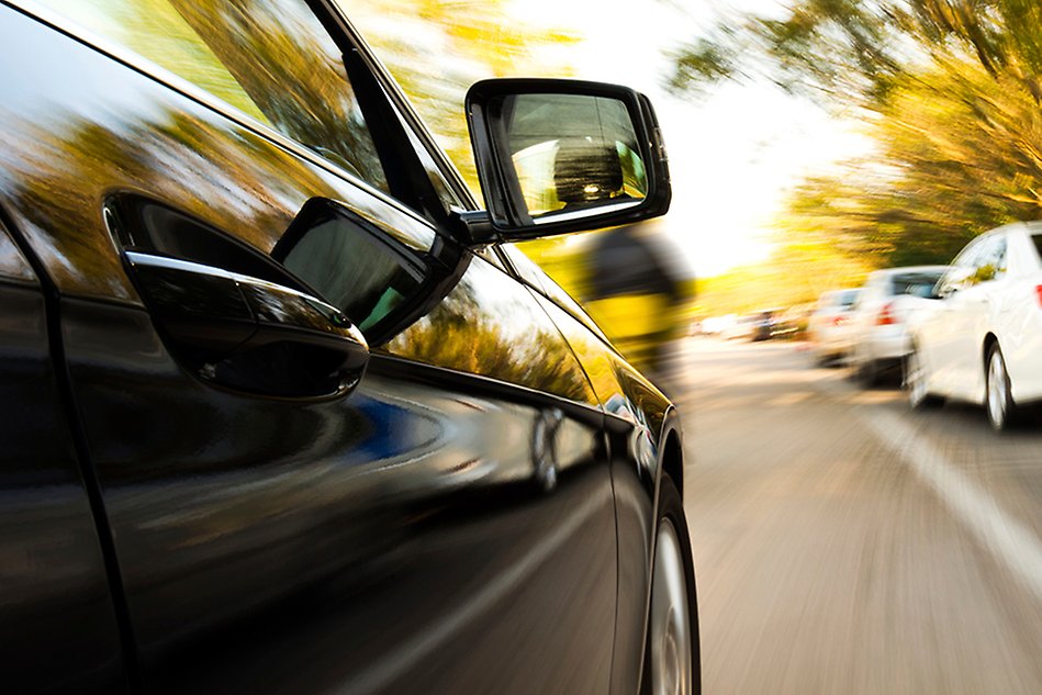 Photo of the side of a driving car