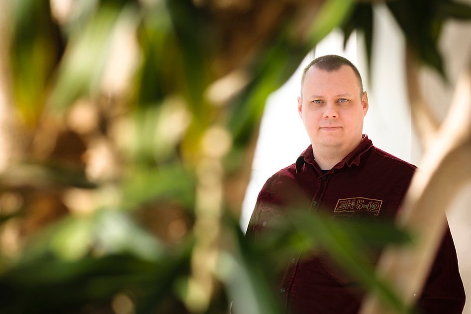 Portrait of a man framed by plants