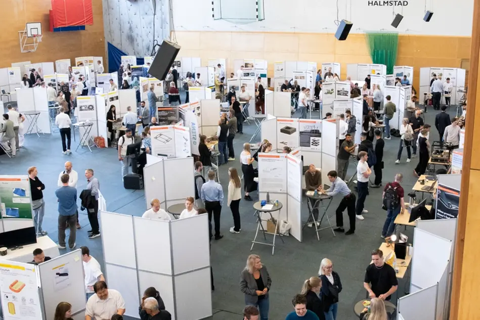 A sports hall with a mass of people and stands with exhibitors. Photo.
