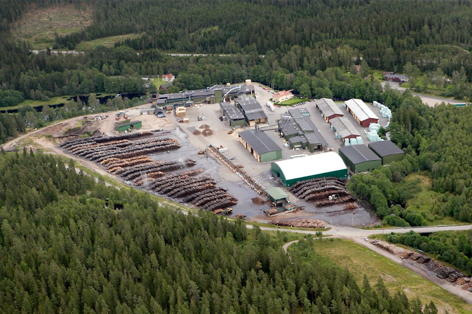 Aerial photo showing a factory surrounded by a forest.
