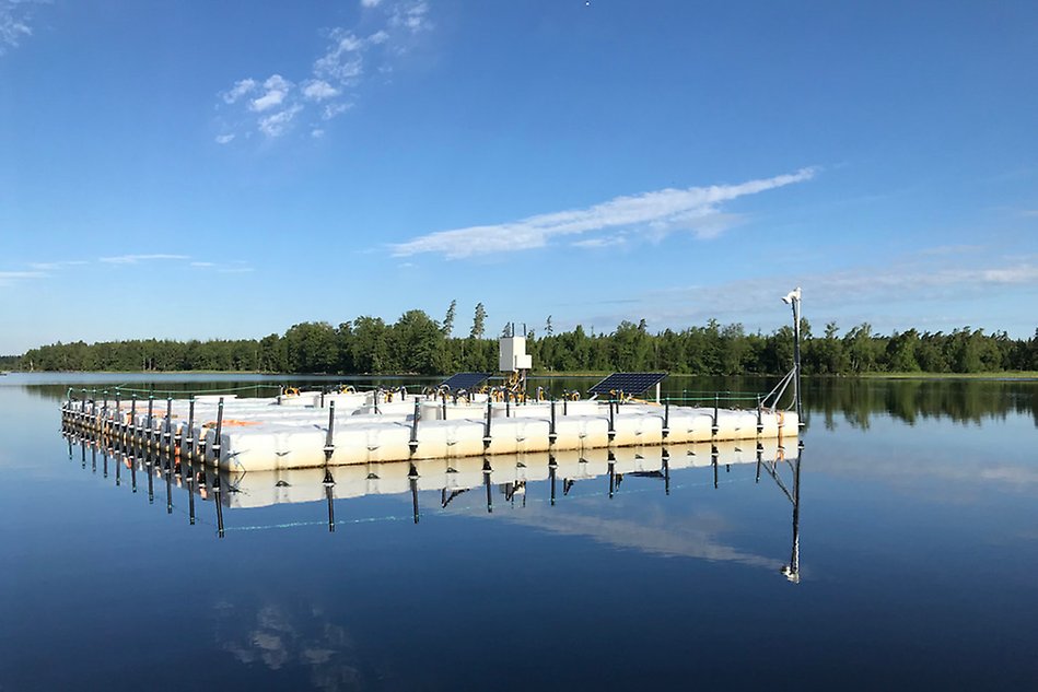 A raft with measuring instruments in a lake. Photo. 