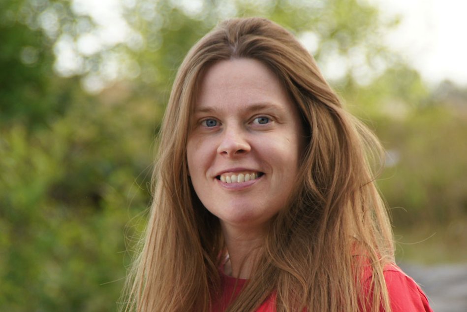 Smiling woman, darkish hair, red top