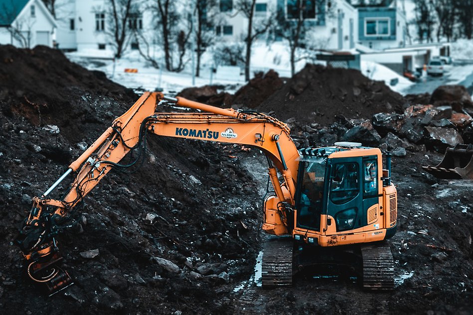 An excavator at a construction site in winter. Photo.