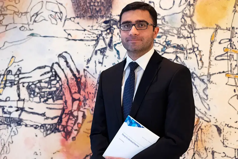 Photo of a man holding a book