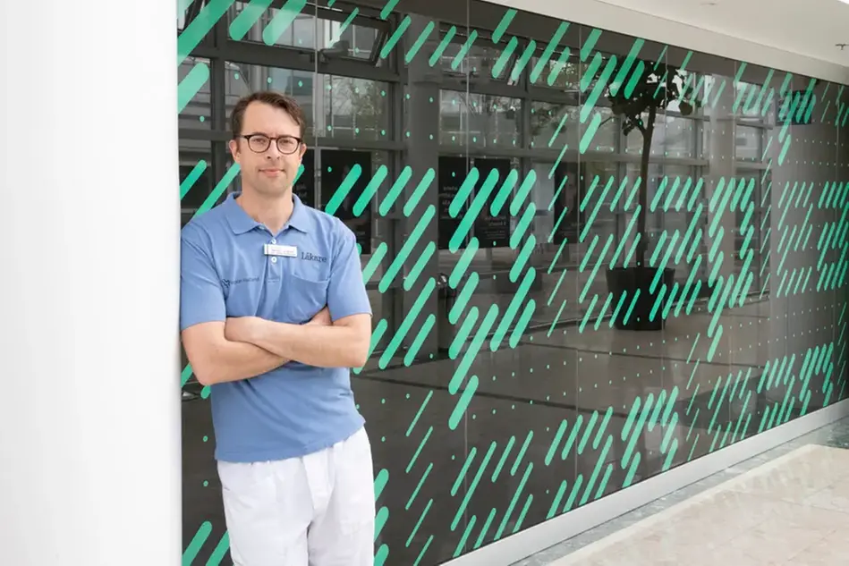 Photo of a man leaning on a wall.