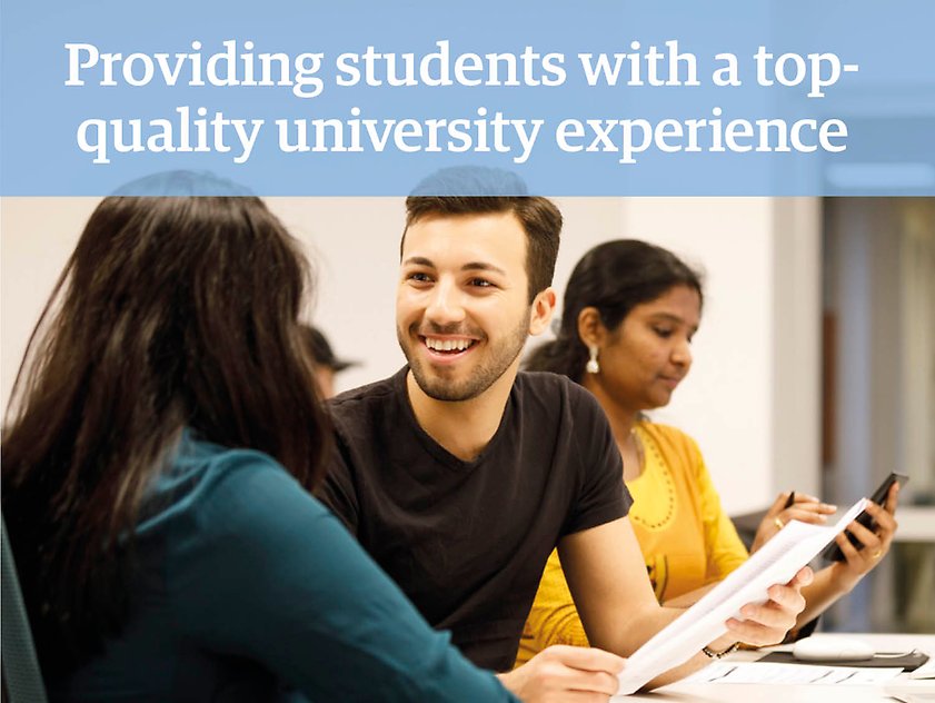 A young man is talking to a woman who is facing away from the camera, the text "Providing students with a top-quality university experience" is printed on top of the photograph.