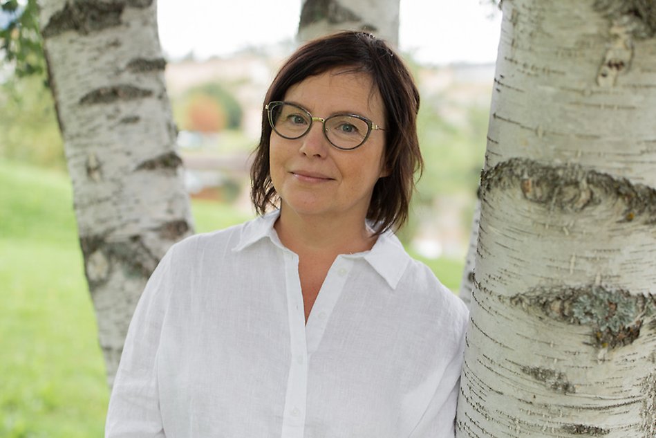 Portrait of a person in a white shirt. Photograph.