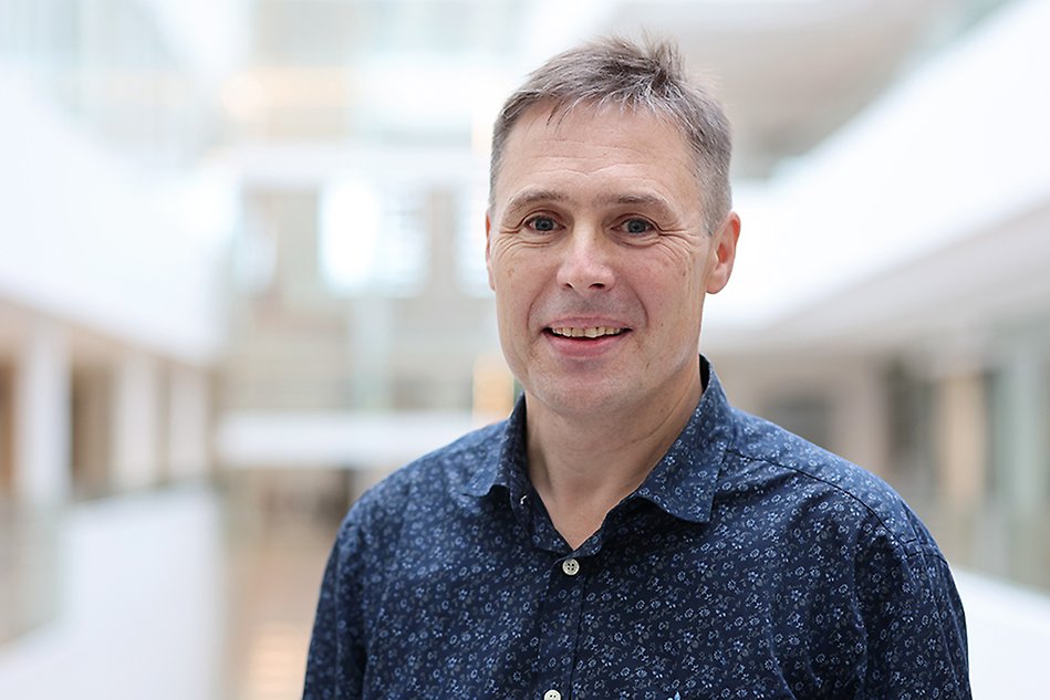 Portrait photo of a man wearing a blue shirt. Photo.