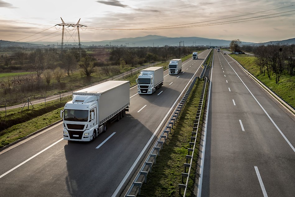 Trucks driving in a convoy on a motorway. Photo.