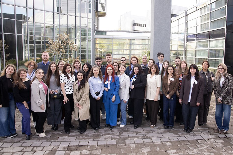 Group of young professionals visiting campus. Photo.